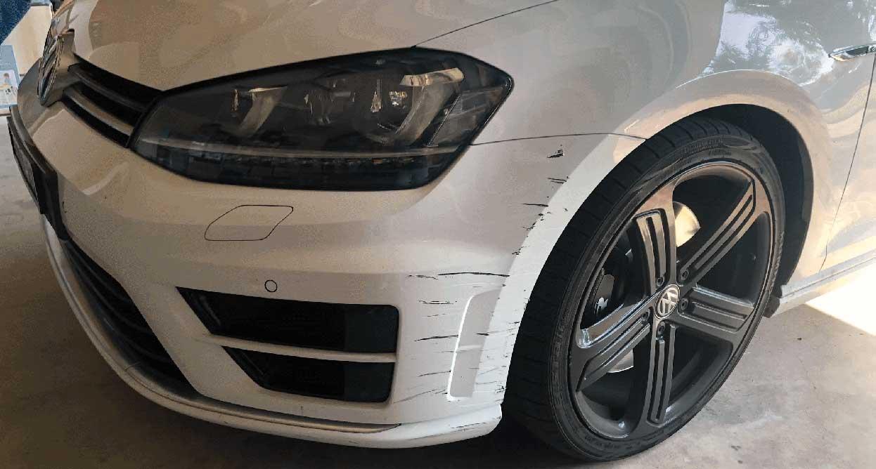 White VW Golf R with front alloy wheel and paint scrape damage